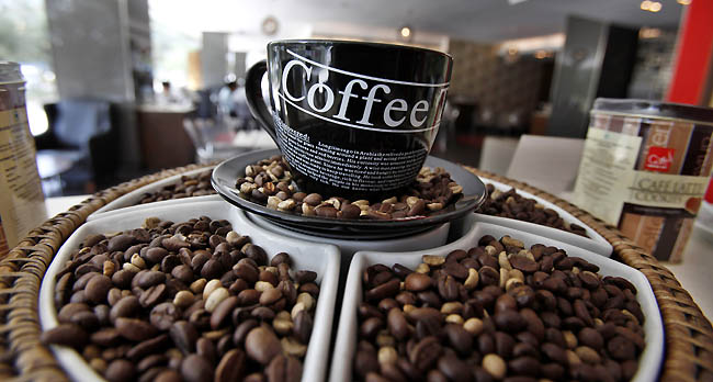 Coffee beans are displayed at a premium Cafe Coffee Day outlet in Bangalore, India, Tuesday, Jan. 31, 2012. Starbucks aims to open 50 outlets in India by year's end, through a 50-50 joint venture with Tata Global Beverages, the companies said Monday. Starbucks currently operates over 17,000 stores in 57 countries. (AP Photo/Aijaz Rahi)